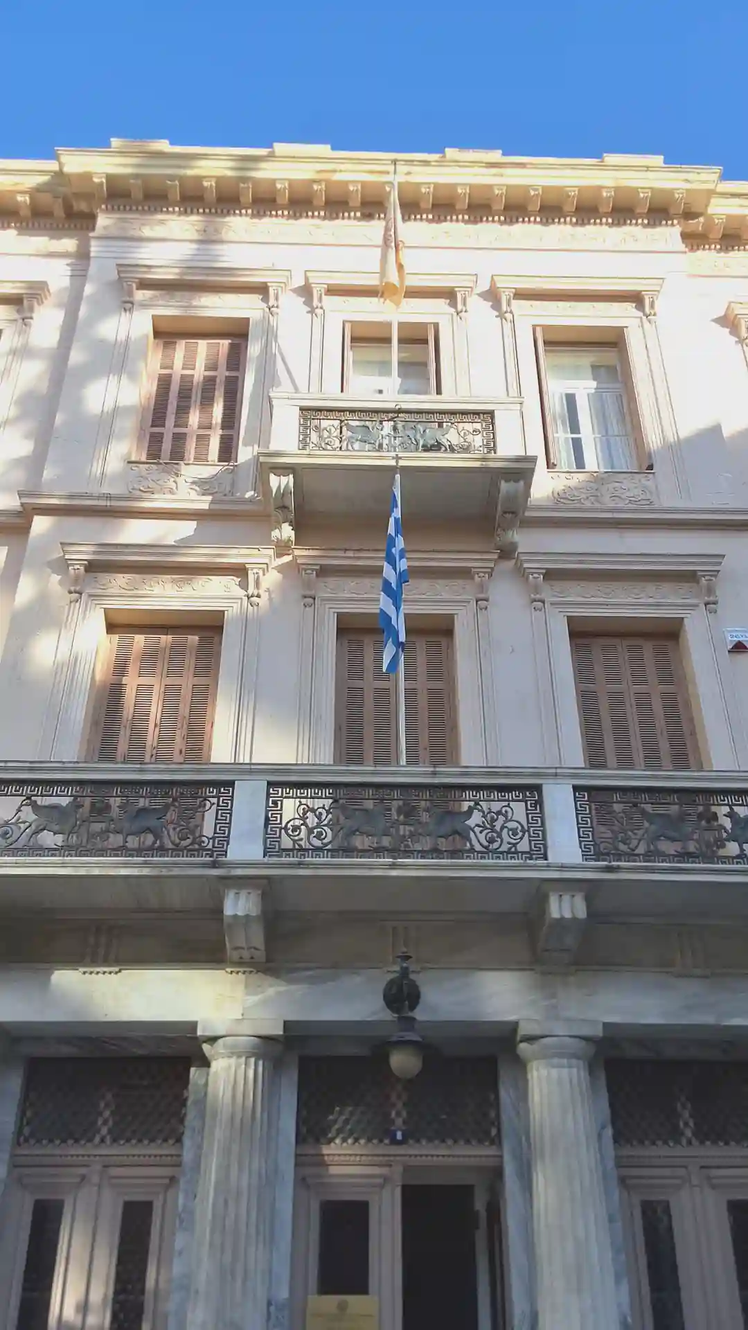 a building with a flag on the balcony