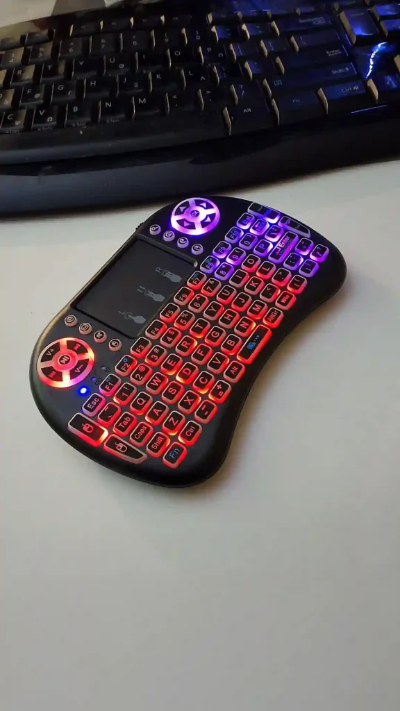 gamepad-styled rgb wireless mini keyboard with touchpad and extra controls and buttons with lit keyboard with many colors